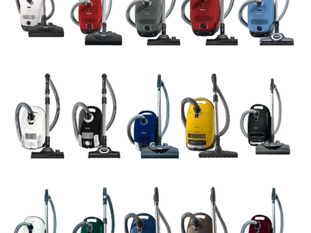 Various colored vacuum cleaners are displayed in rows on a white background. They feature hoses and floor attachments, showcasing different models.
