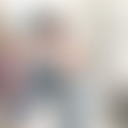 mother and son sitting in the kitchen,  packing a back pack for school 