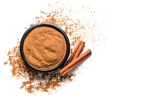 cinnamon-powder-with-cinnamon-sticks-shot-from-above-on-white-background.webp_b=1&s=170667