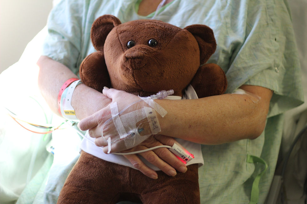 Thumbnail: Bear being held against a womans chest after surgery