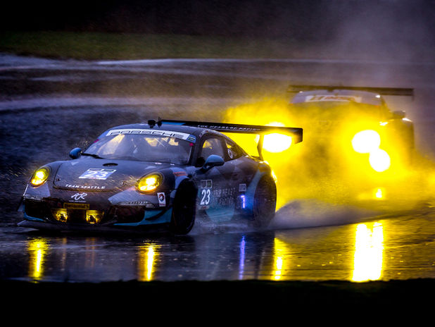 Porsche on flooded track during race