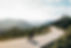 cyclist riding bike sunset mountain road