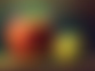 Two stylized apples, red and yellow, with leaves, placed side by side on a textured surface. The background is blurred with warm hues.