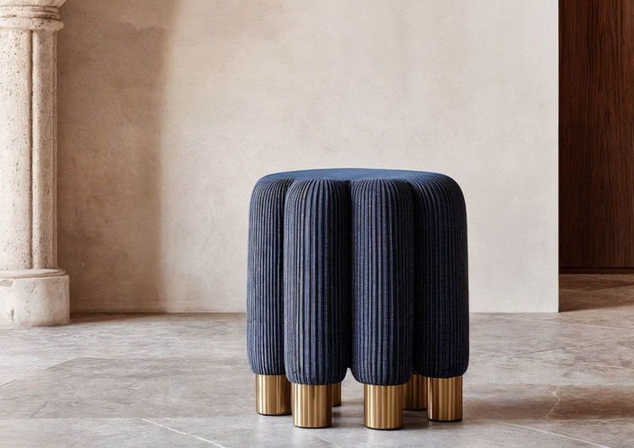 organic sculptural pouf, sea anemone inspired stool, designer accent pouf with brass legs, limited edition round pouf, luxury soft seating for modern interiors, Italian sculptural pouf design, underwater inspired velvet pouf, sculptural ottoman with vertical tufting, oceanic design accent furniture, collectible designer pouf limited series