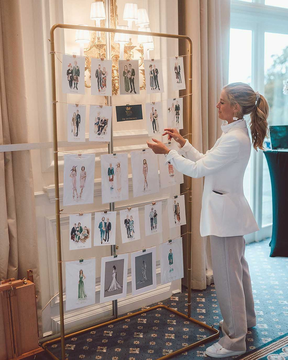 Daria van Vliet with wall of guest illustrations