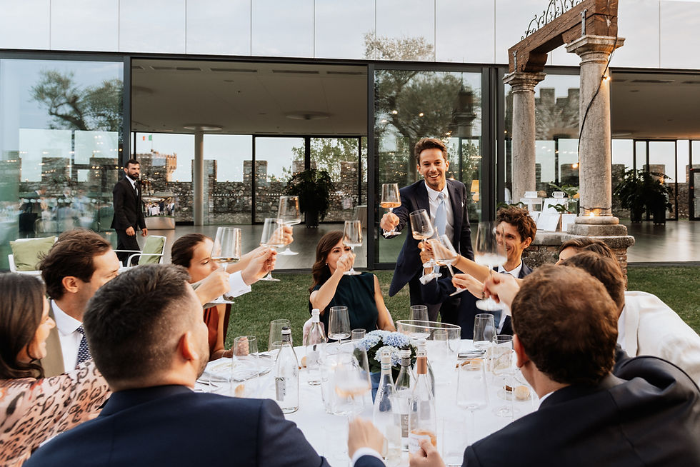 Wedding guests toasting with wine glasses at a Tuscany reception