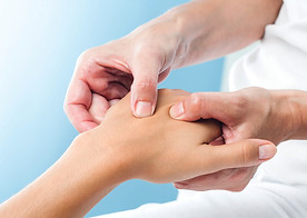Osteopath treating hand injury