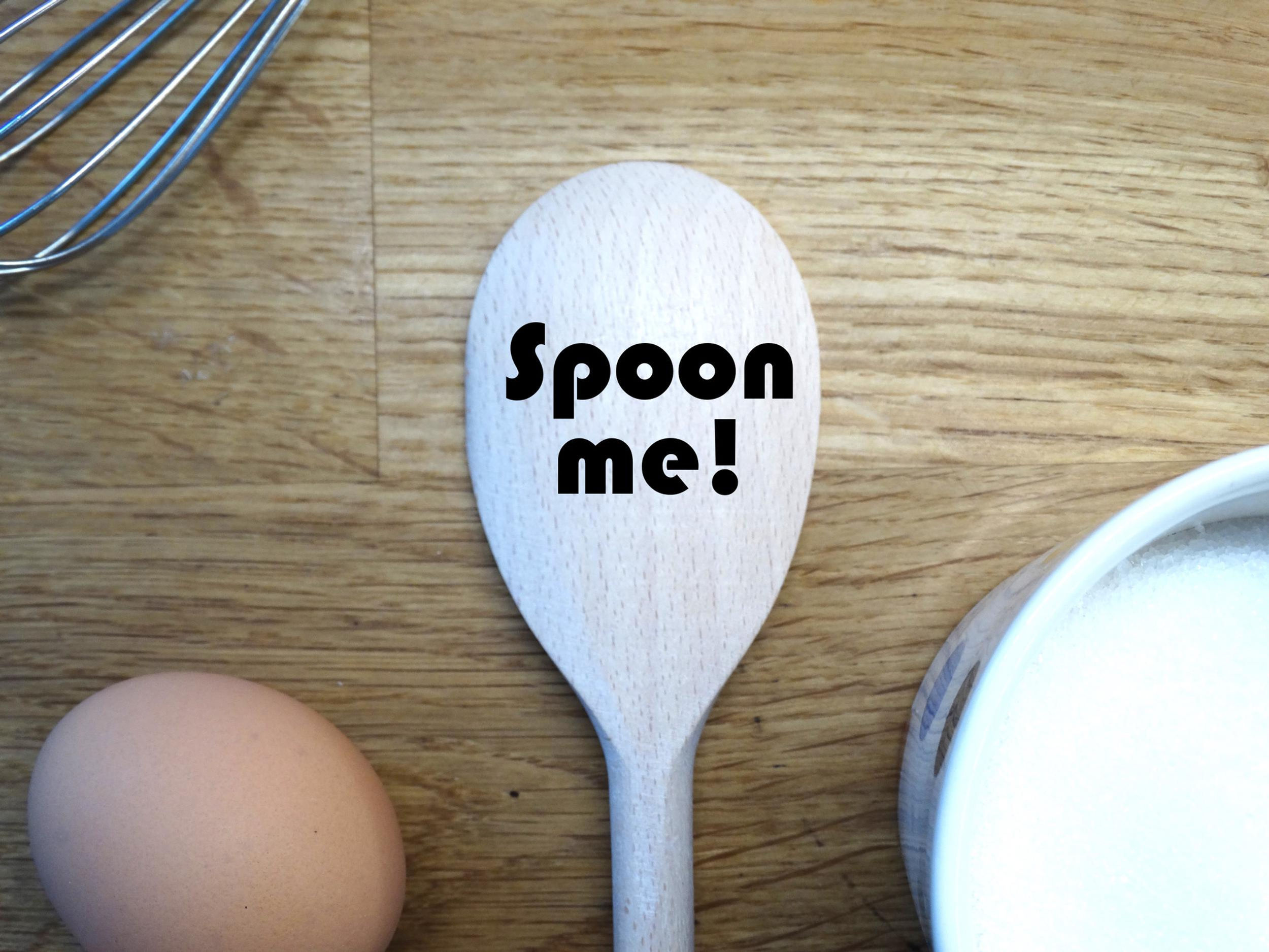 Example of a wooden spoon for customers to see what they could get. Showing an engraving of Spoon Me text as a gift