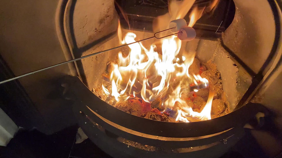 Thumbnail: s'more on an extendable stick, which has a personalised handle, and is being toasted on a fire