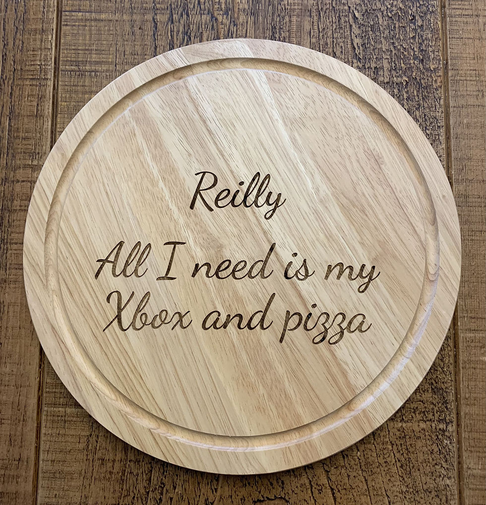 Thumbnail: 30cm round wooden pizza board personalised with an engraving of a family name and 'Pizza Night'. Gift available to buy.