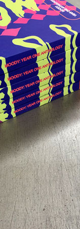 A stack of brightly colored softcover books with laminated covers and full bleed printing