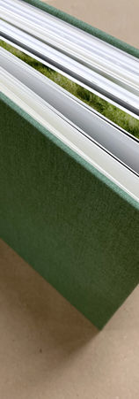 A hardcover hand sewn wedding photo book in green cloth with gold foil stamping