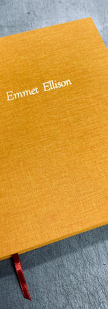 A hand bound hardcover book with yellow cloth and foil stamping