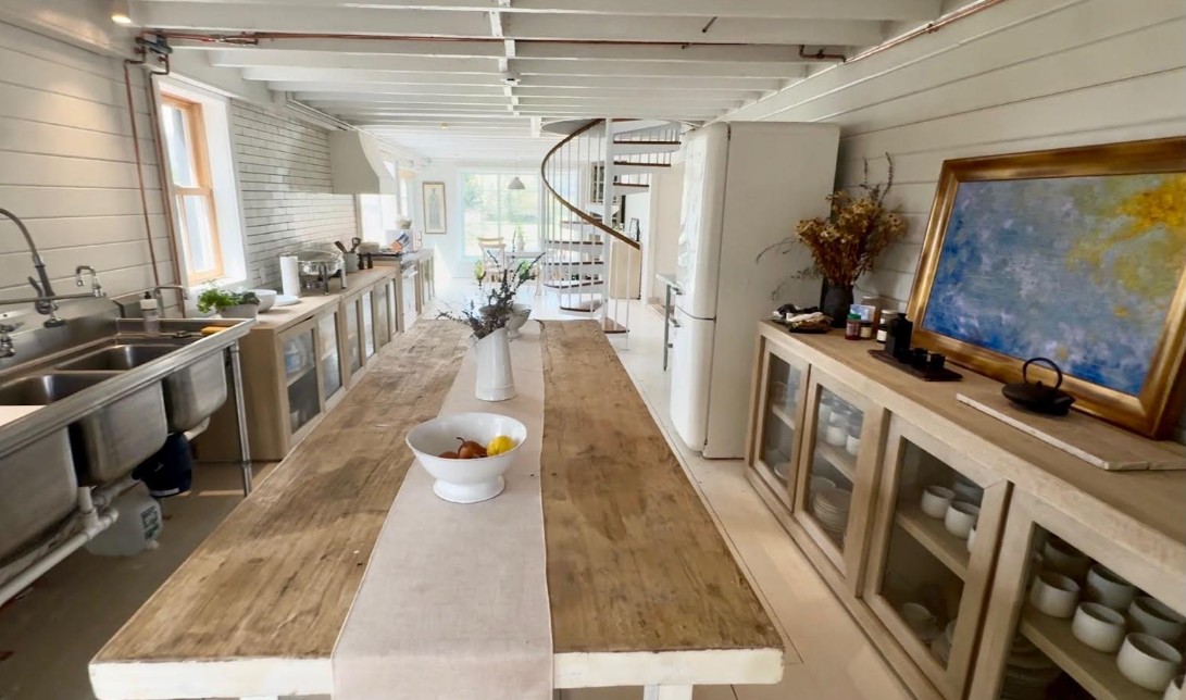 The catering kitchen: double sinks, stainless prep, glass-front storage