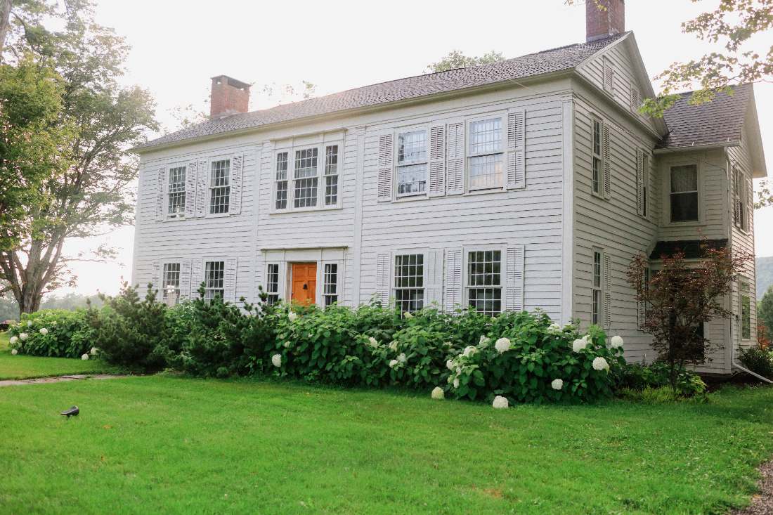 The 1790s farmhouse with hydrangeas in bloom