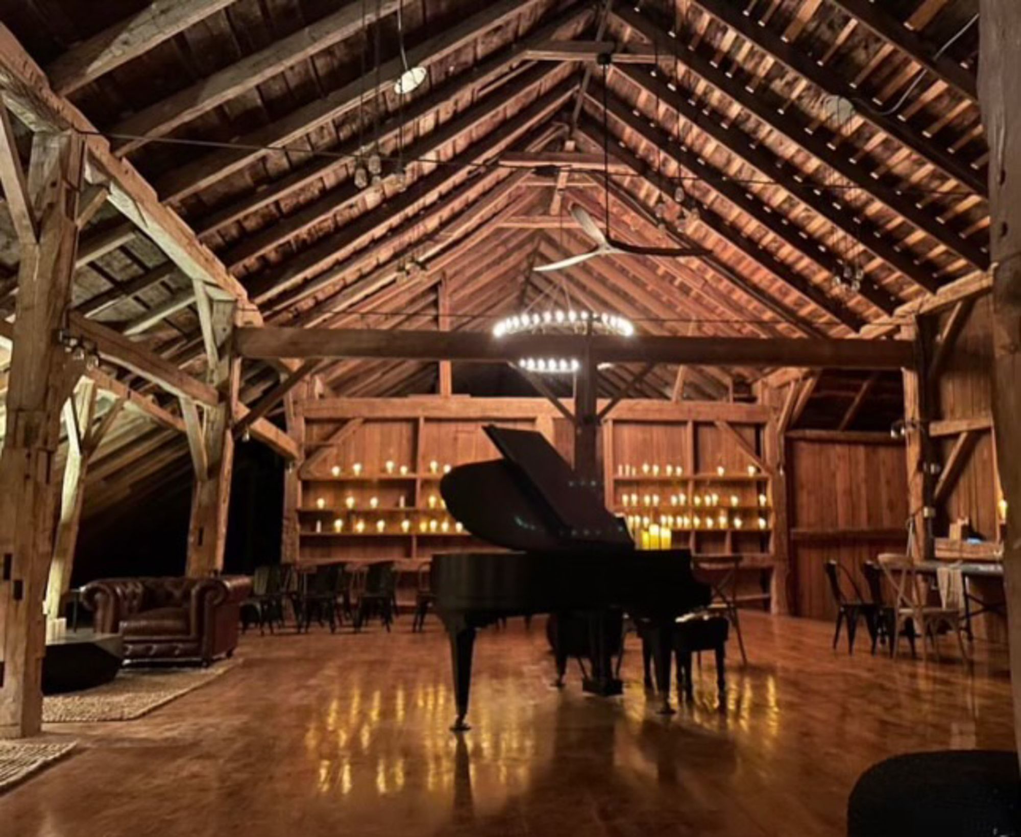 The piano in the upper Barn against the candle wall