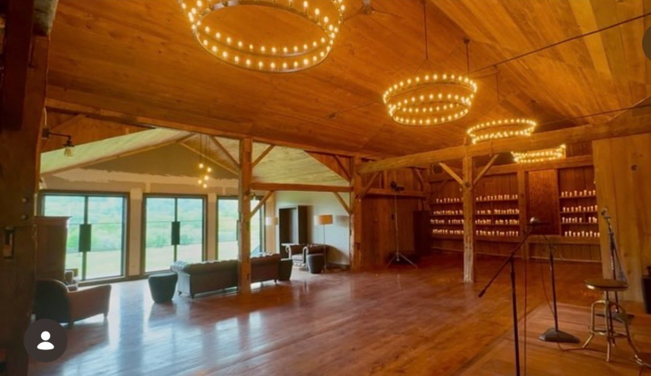 The upper Barn under ring chandeliers, candles along the wall