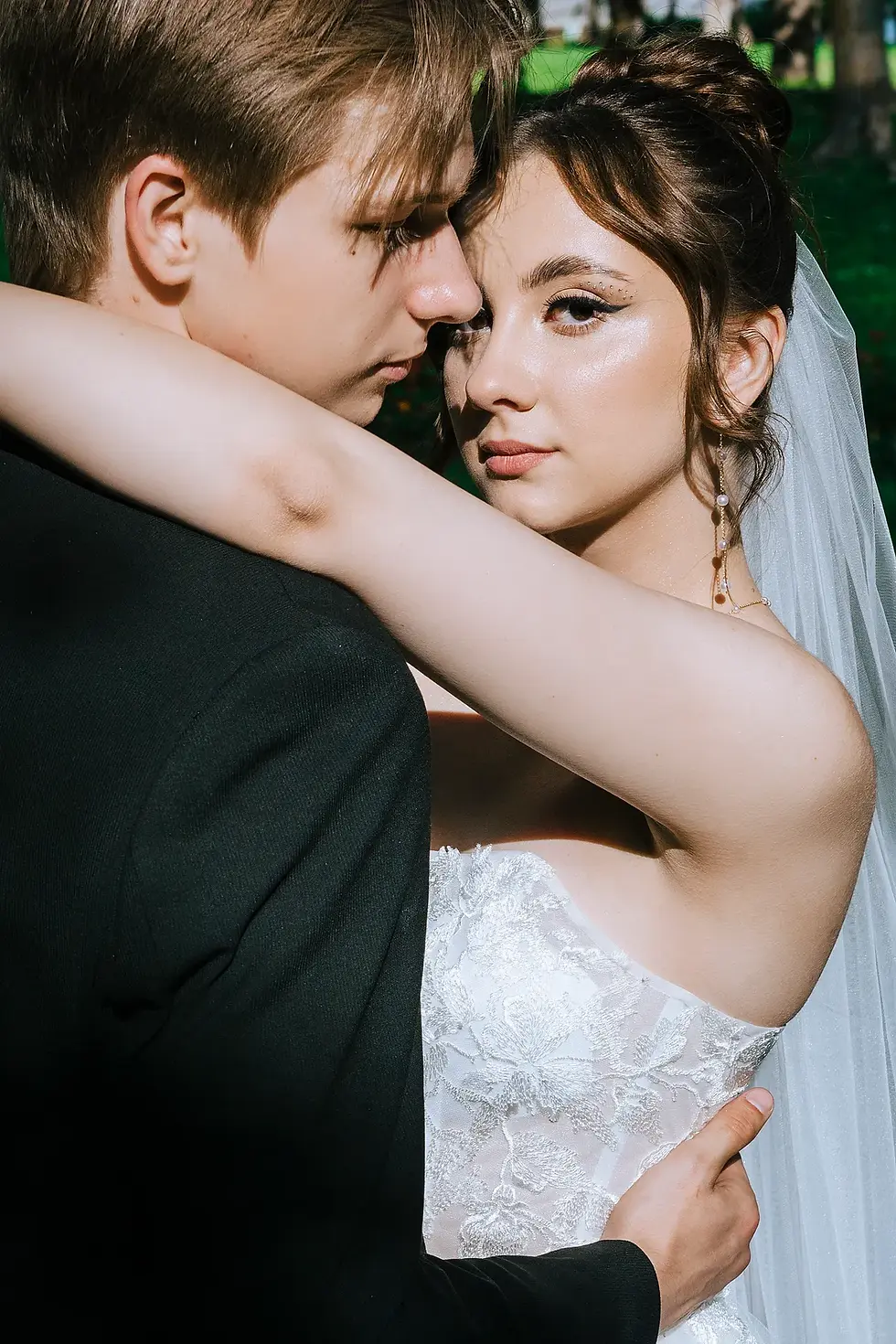 Bride and groom portrait in soft natural light in a garden setting