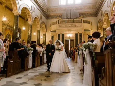Father walking his daughter down the aisle at her wedding ceremony