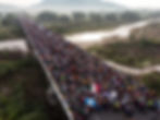 Thousands of people crossing over a bridge