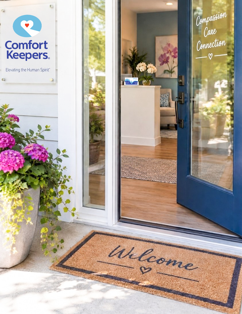 Mockup of storefront with door open, welcoming customers in. Door says "Compassion, Care, Connect". Logo is on placard on wall as you enter, to left of door with business tagline - "Elevating the Human Spirit". Business card with blue boat design is visible in center of image on reception area desk.