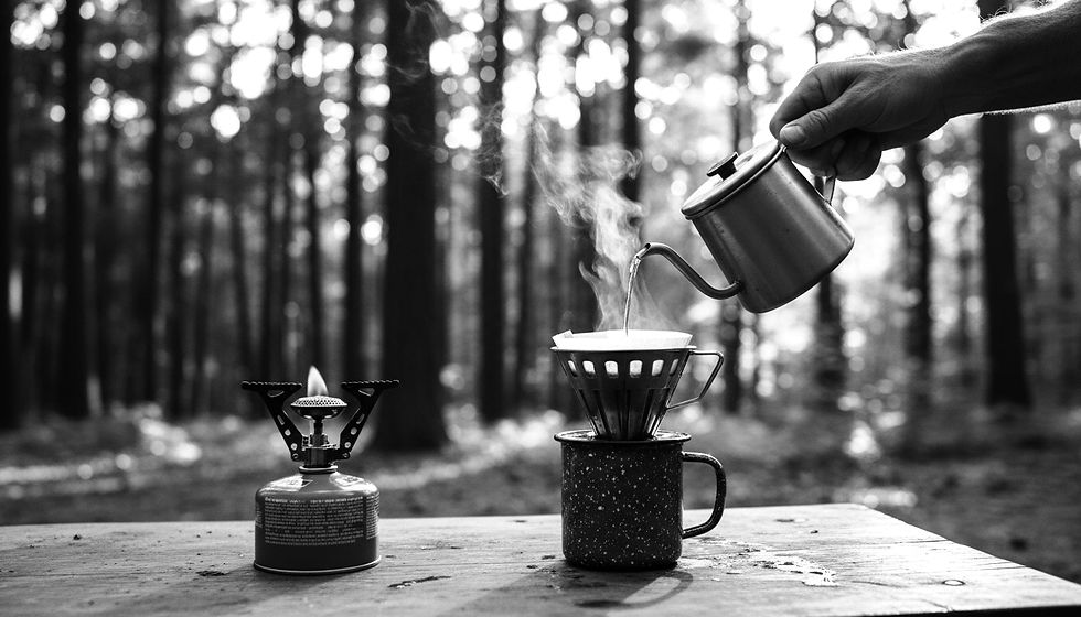 Eye-level view of a camper pouring hot water into a metal pour-over cone