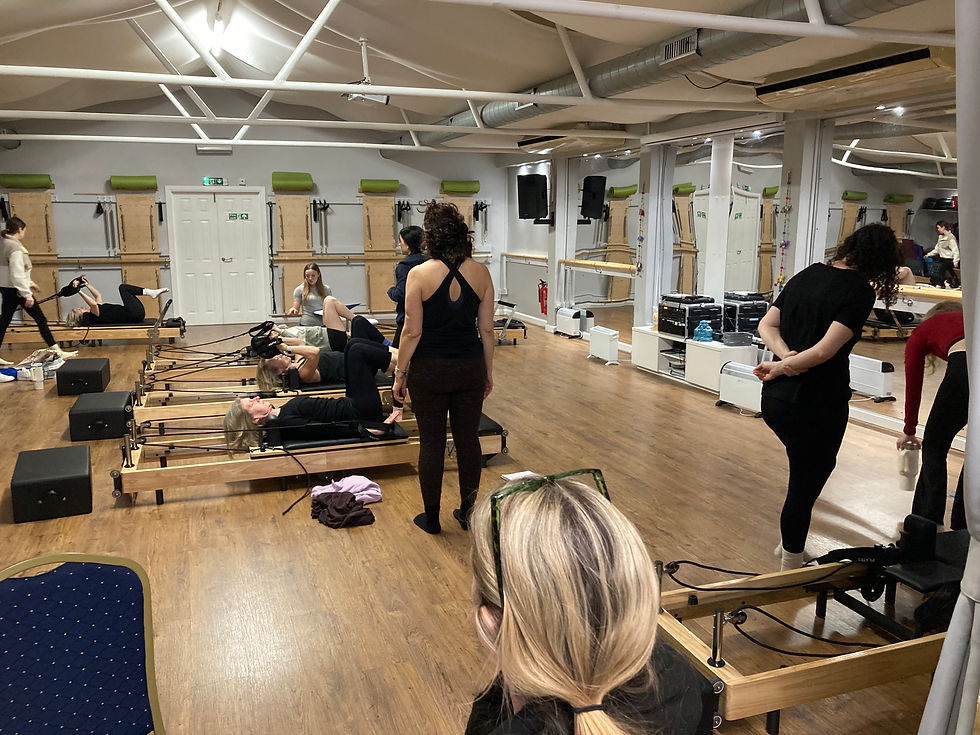 Eye-level view of Pilates reformer machine in a bright studio