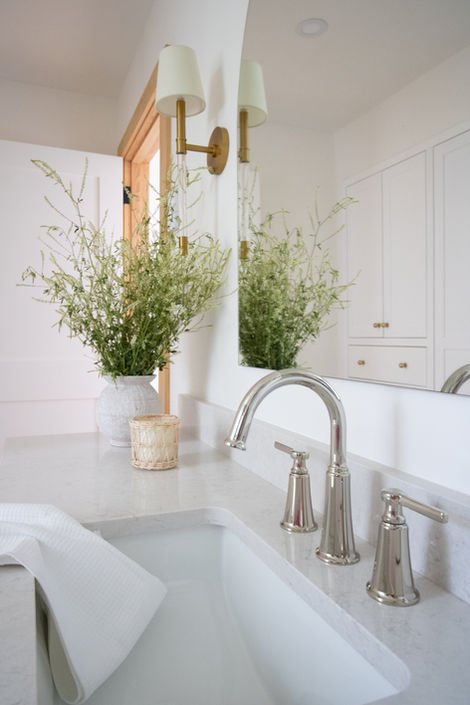 New bathroom faucet and plants accentuate a beautiful bathroom makeover