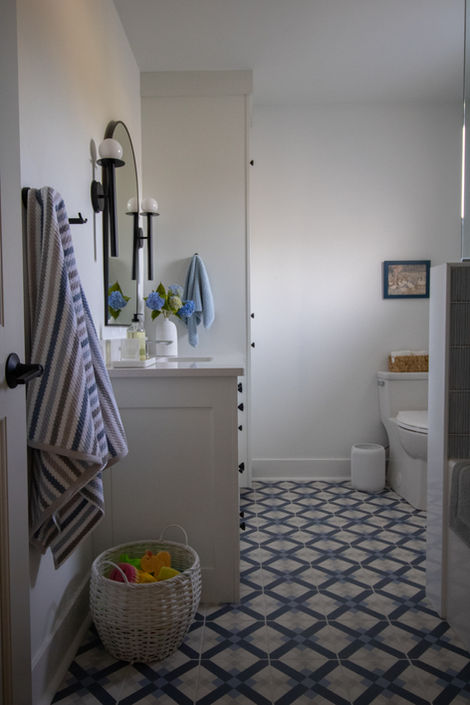 Unique tile flooring in a bathroom renovation gives a coastal design vibe