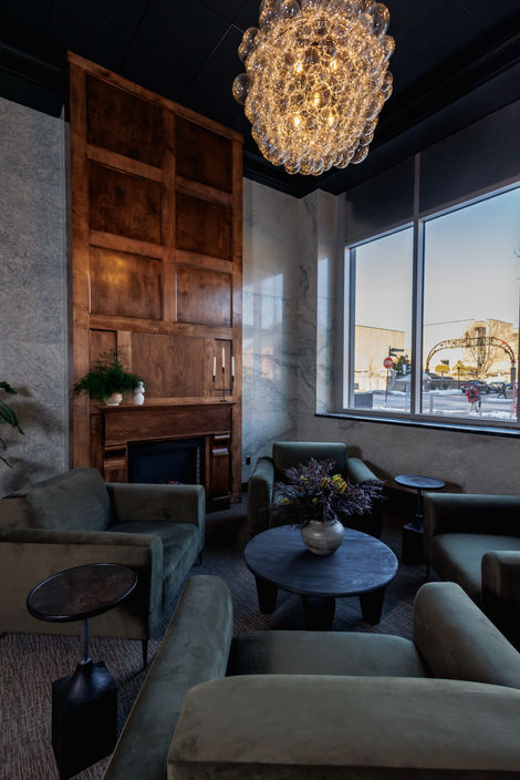 Club chairs are set around a small round table inside a Charlottetown building