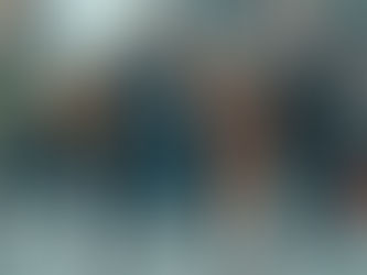 Five friends walk down a city street, smiling and chatting. They wear winter clothes. A Canadian flag is visible in the background.