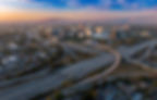 Wide view of city showing highways and buildings to represent Univerus Assets' efficient infrastructure tracking
