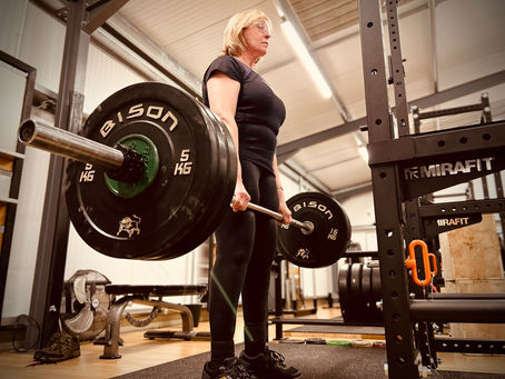 76-year-old female member performing a barbell deadlift at PB Strength & Fitness Mentoring gym in Ashbourne, Derbyshire, showing the benefits of strength training at any age.