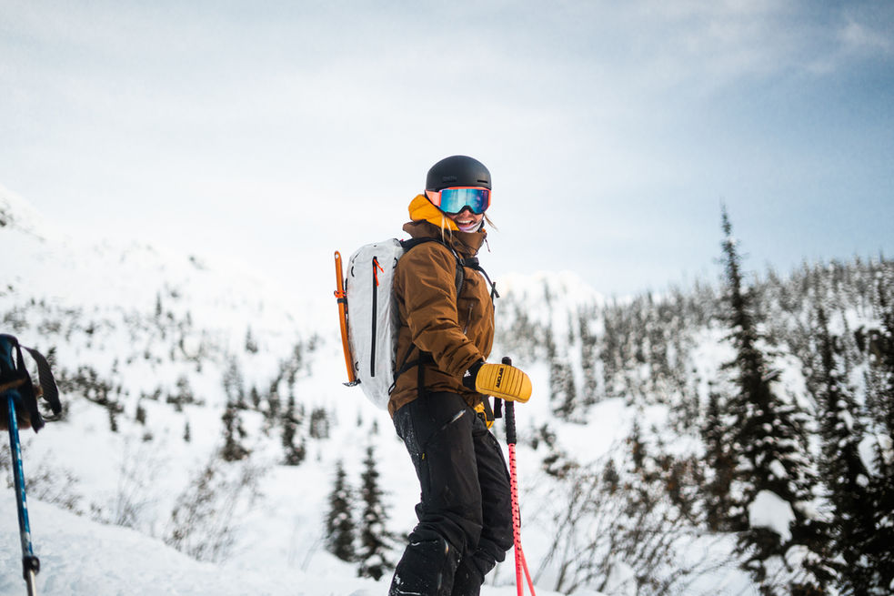 Skier trekking with essential gear

