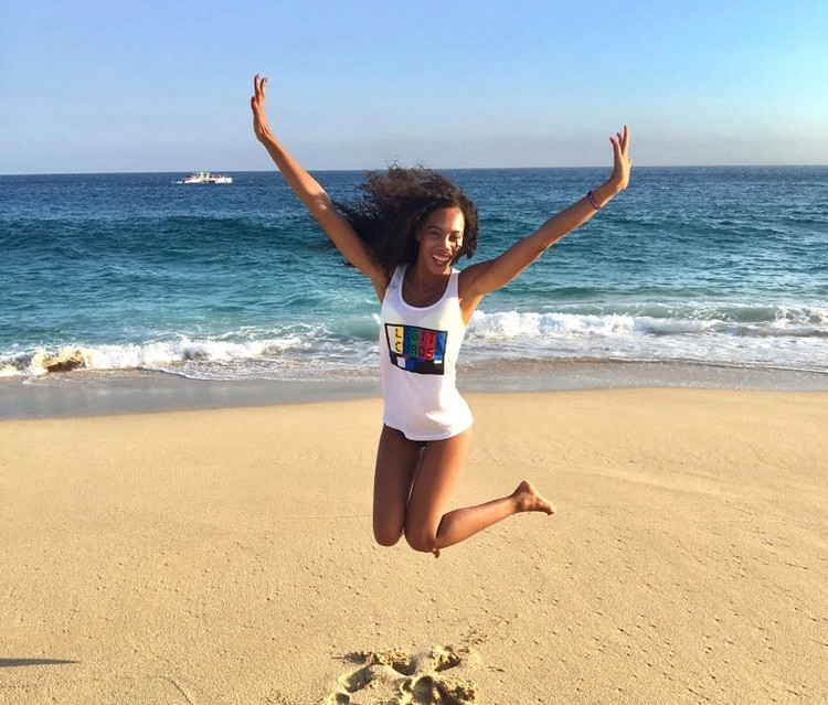 picture of Kaje jumping in the air at the beach
