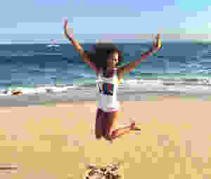 picture of Kaje jumping in the air at the beach