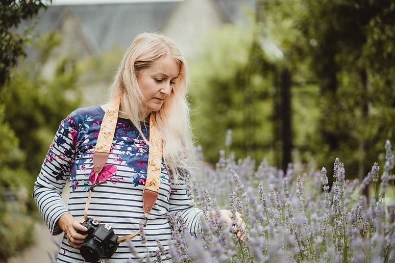 A Photo Coach student looking for photography inspiration in a garden setting