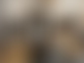 Stainless steel coffee maker brewing coffee into glass container in a minimalist kitchen