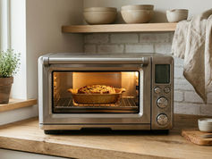 Modern stainless steel toaster oven on kitchen counter with interior light