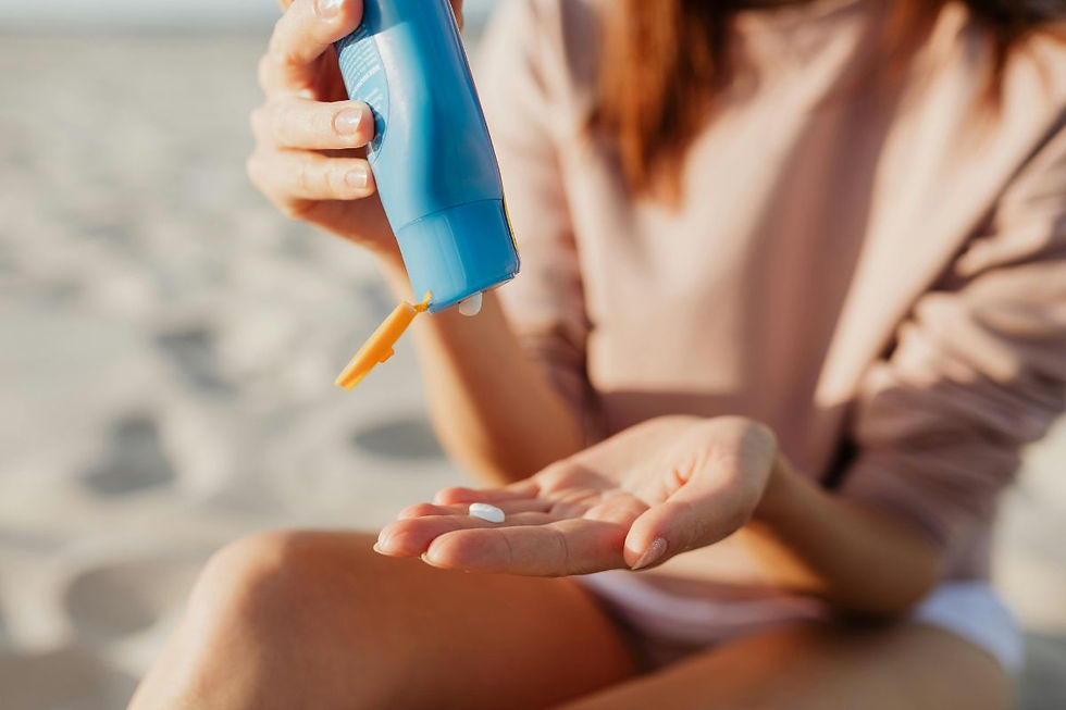 Woman on the beach applying reef-safe sunscreen.