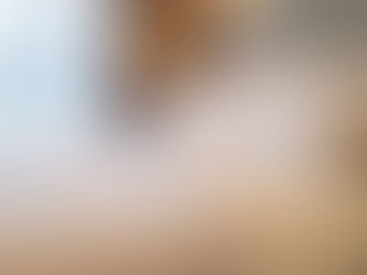 Minimalist bedroom with white organic cotton pillows and duvet near window light, illustrating breathable and healthy sleep materials