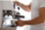 Person making espresso at home using a semi-automatic espresso machine