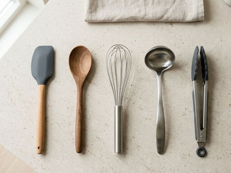kitchen utensils made from silicone wood and stainless steel arranged in a utensil holder