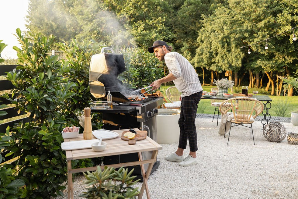 Person grilling outdoors in a peaceful garden setting