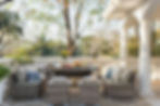 ushioned rattan dining lounge on a sunlit terrace styled for summer brunch with greenery.