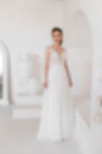Bride wearing ‘bed of roses’ GR270 by Gilded Rose A-line wedding dress featuring a detailed lace bodice, wide straps, plungin