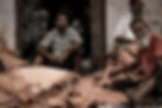 Indian men sitting in shop front