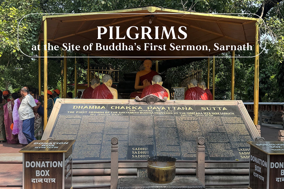 Pilgrims at the site of Buddha's First Sermon in Saranath, India. Buddha statue surrounded by statues of monks.