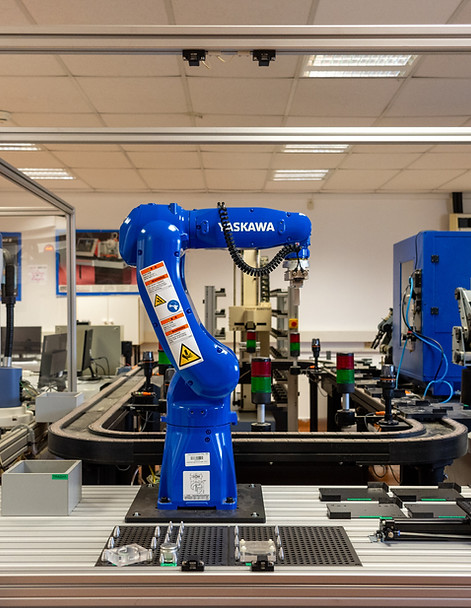 Blue robotic arm in the front, lab D106 in the background