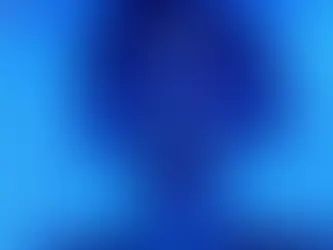 A woman is laying in a tanning bed in blue lighting. She has blue tanning goggles over her eyes and is screaming.